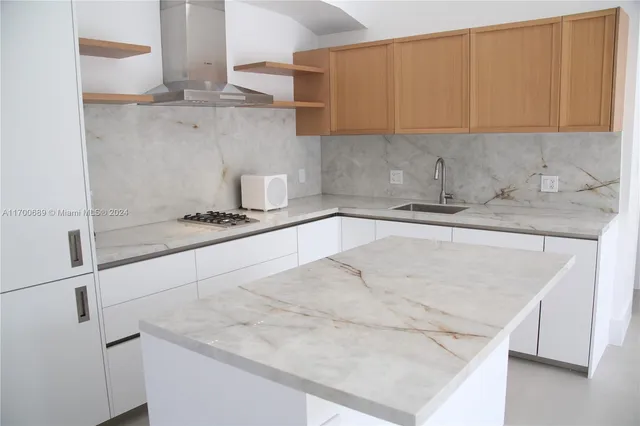 a front view of a house with a yard and potted plants