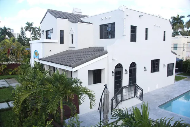 a view of a hallway with wooden floor and windows