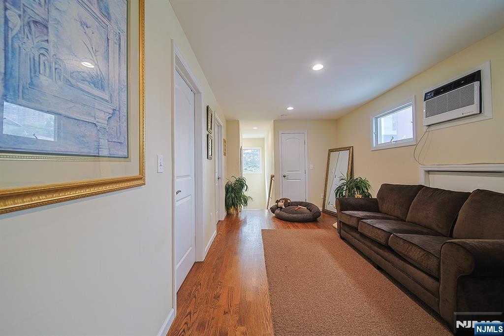 1003 Cumbermeade Road Fort Lee, NJ 07024 - Photo 15 of 38 a hallway with a couch and a potted plant