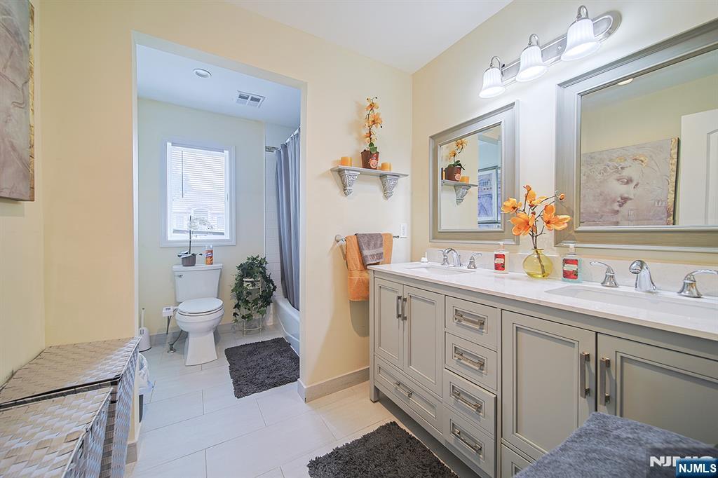 1003 Cumbermeade Road Fort Lee, NJ 07024 - Photo 16 of 38 a spacious bathroom with a double vanity sink mirror and toilet