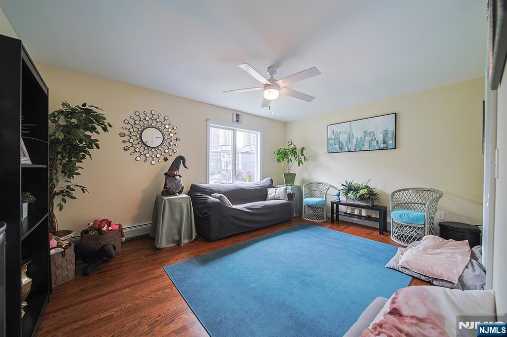 1003 Cumbermeade Road Fort Lee, NJ 07024 - Photo 18 of 38 a living room with furniture and a flat screen tv