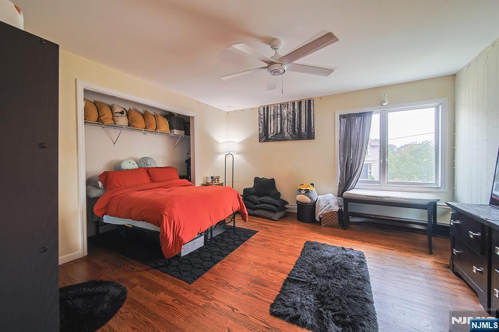 1003 Cumbermeade Road Fort Lee, NJ 07024 - Photo 19 of 38 a spacious bedroom with a bed a couch and a window