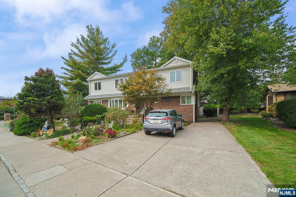 1003 Cumbermeade Road Fort Lee, NJ 07024 - Photo 2 of 38 a car parked in front of a house next to a yard