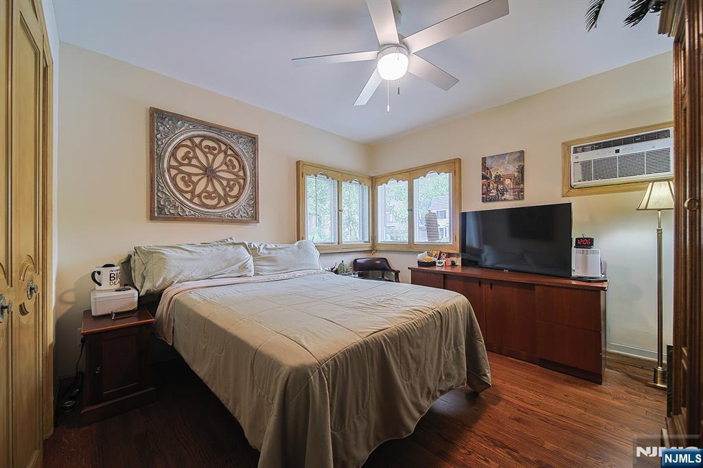 1003 Cumbermeade Road Fort Lee, NJ 07024 - Photo 22 of 38 a bedroom with a bed and a flat screen tv