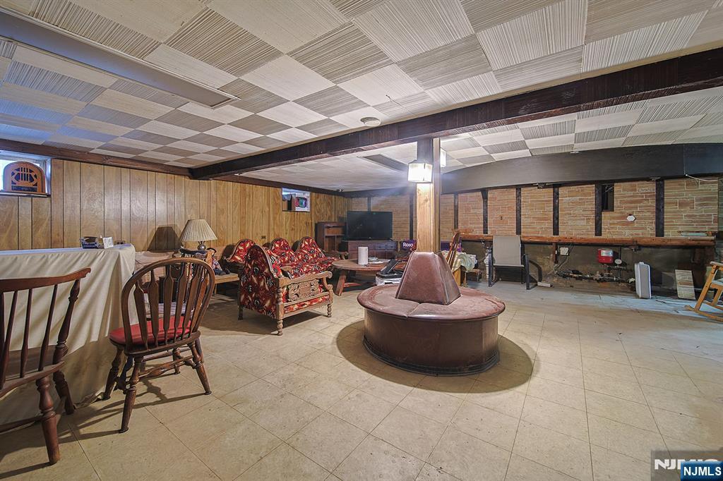 1003 Cumbermeade Road Fort Lee, NJ 07024 - Photo 28 of 38 a room with lots of chairs and a chandelier