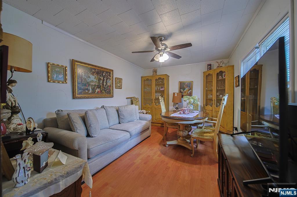1003 Cumbermeade Road Fort Lee, NJ 07024 - Photo 31 of 38 a living room with furniture a piano and a flat screen tv