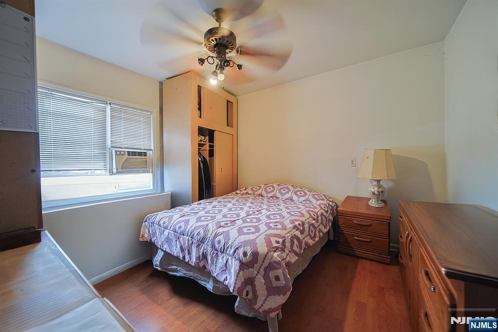 1003 Cumbermeade Road Fort Lee, NJ 07024 - Photo 33 of 38 a bedroom with a bed and a chandelier