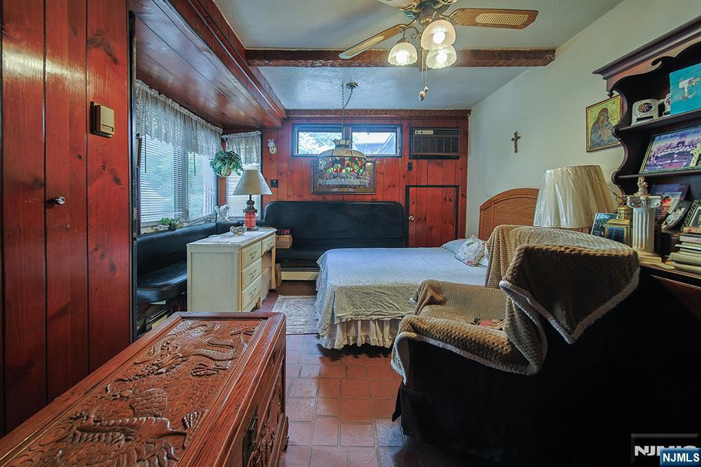 1003 Cumbermeade Road Fort Lee, NJ 07024 - Photo 37 of 38 a living room with furniture a flat screen tv and a fireplace