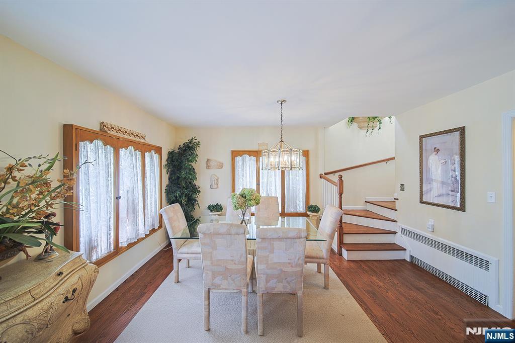 1003 Cumbermeade Road Fort Lee, NJ 07024 - Photo 9 of 38 a dining room with furniture a chandelier and wooden floor