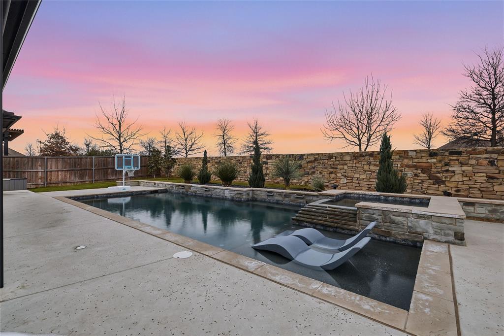 a view of swimming pool with a yard and lake view