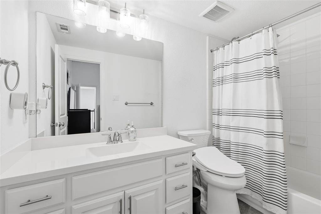 6508 Cooper Creek Road Flower Mound, TX 76226 - Photo 24 of 39 a bathroom with a sink a toilet and shower
