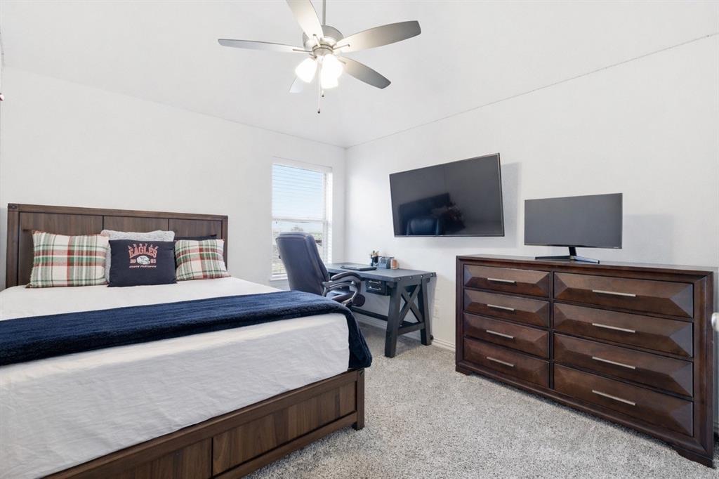 6508 Cooper Creek Road Flower Mound, TX 76226 - Photo 32 of 39 a bedroom with a bed and a flat screen tv