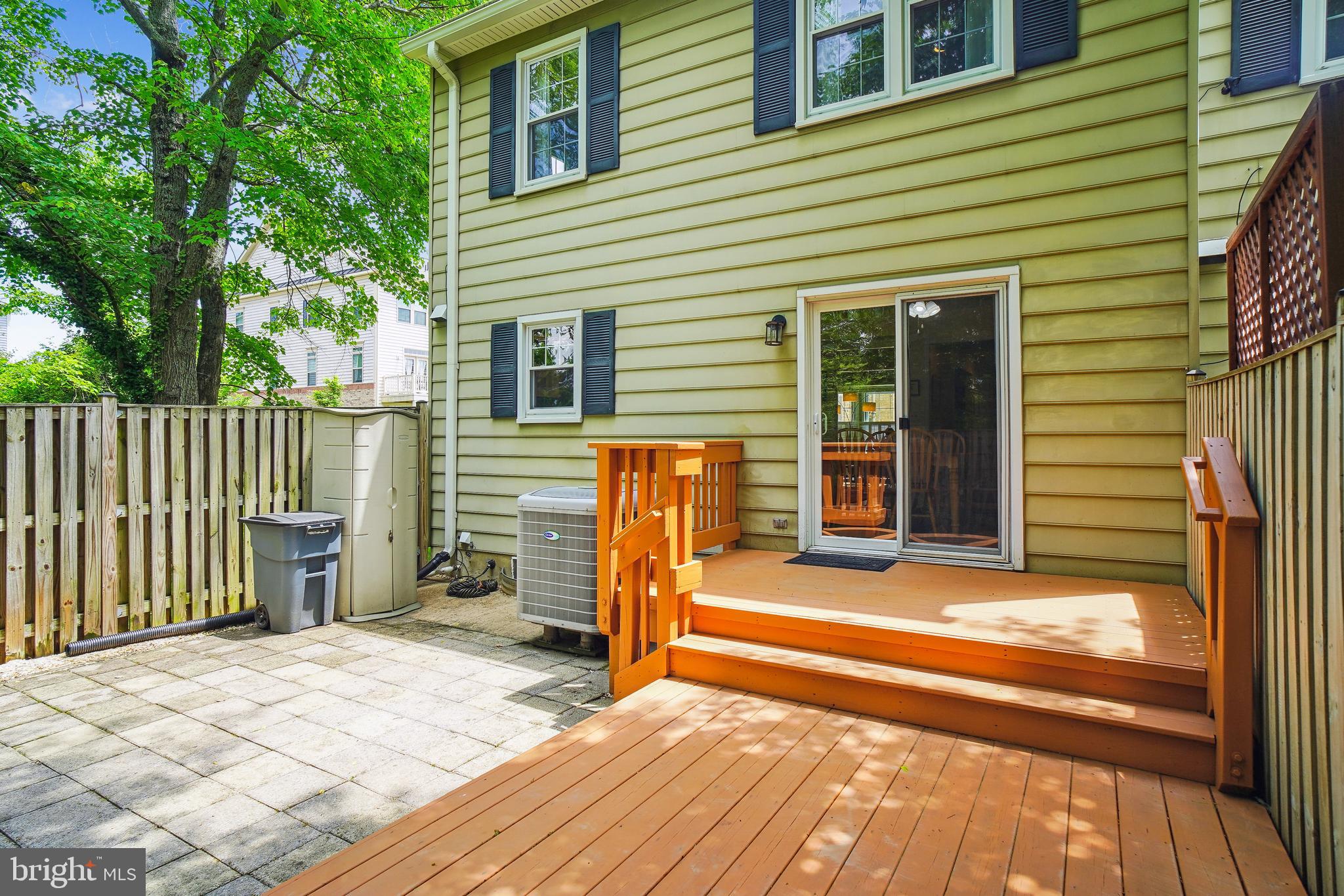 1049 Windrush Lane, Unit 2 Sandy Spring, MD 20860 - Photo 42 of 59 a view of a house with a patio and wooden fence