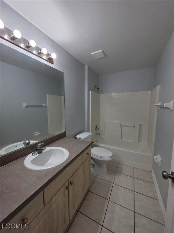 2502 Park Road Lehigh Acres, FL 33971 - Photo 13 of 17 a bathroom with a granite countertop sink a toilet a mirror and a shower