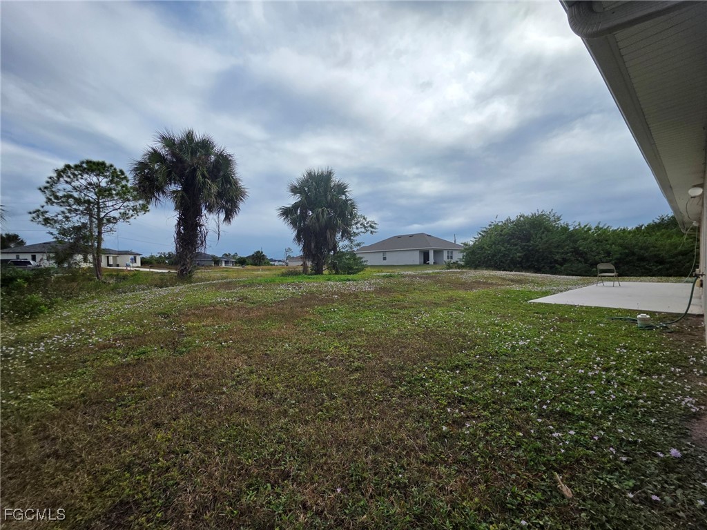 2502 Park Road Lehigh Acres, FL 33971 - Photo 16 of 17 a view of outdoor space with deck and green space