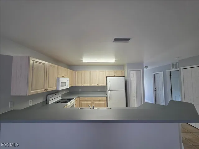 a kitchen with stainless steel appliances granite countertop a refrigerator and a stove