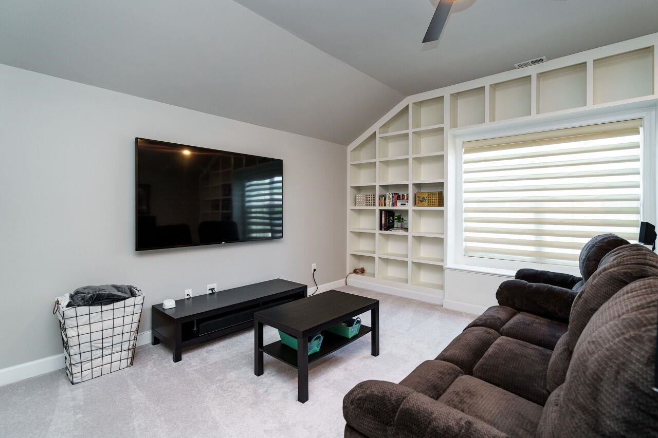 3003 Red Grape Drive Raleigh, NC 27607 - Photo 29 of 35 Unlimited potential here in this sweet space! Built in bookshelves make this room fun and practical. Home theatre is a great option! Tons of unfinished storage off this room too! Bonus Room