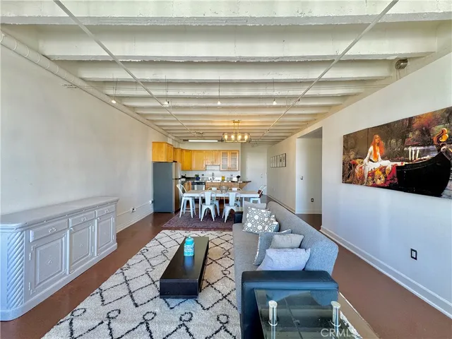 a view of a dining room with furniture a chandelier and wooden floor