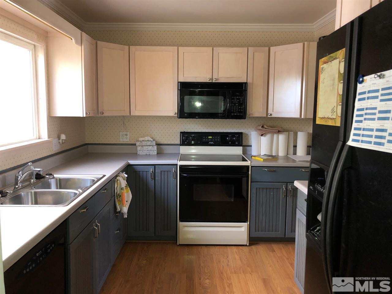 860 Yori Avenue Reno, NV 89502 - Photo 6 of 24 a kitchen with a sink stove and microwave