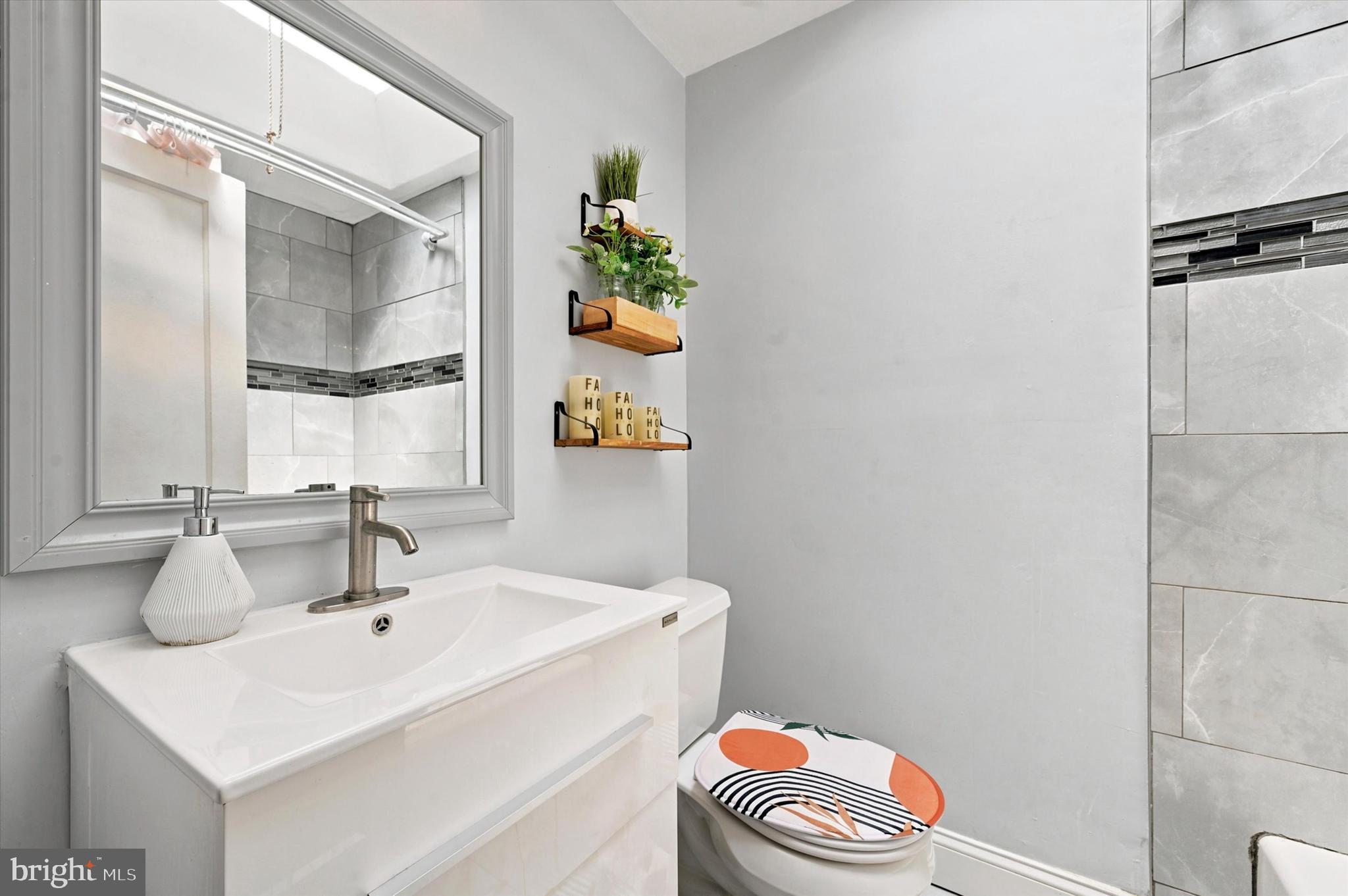 268 Blanchard Road Drexel Hill, PA 19026 - Photo 10 of 15 a bathroom with a sink toilet and mirror