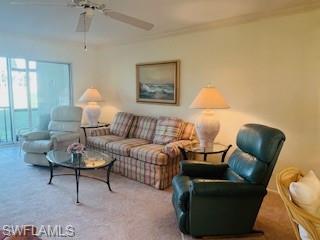 41 High Point Circle South, Unit 104 Naples, FL 34103 - Photo 3 of 16 a living room with furniture and a potted plant