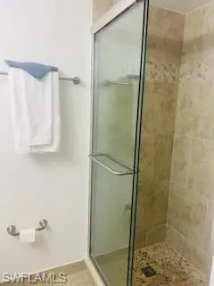 a bathroom with a glass shower door