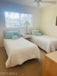 a bedroom with two beds and a large window