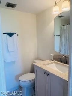 a bathroom with a sink toilet and mirror