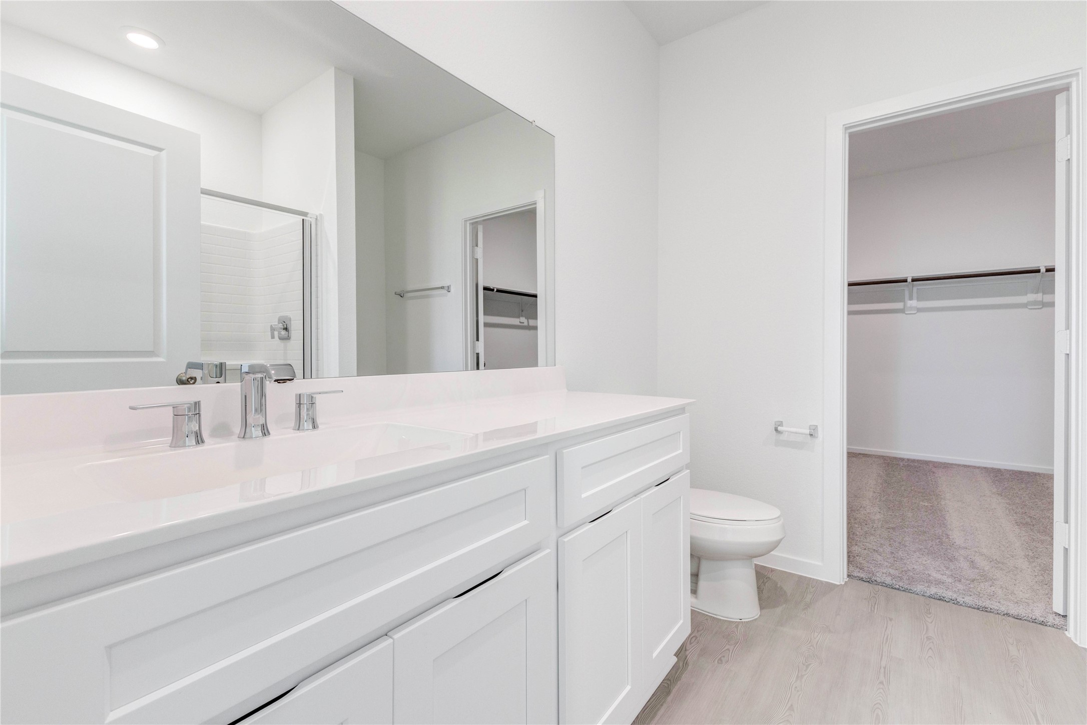 15011 Rustic Moon Road Conroe, TX 77302 - Photo 17 of 26 a bathroom with a sink toilet a mirror and shower