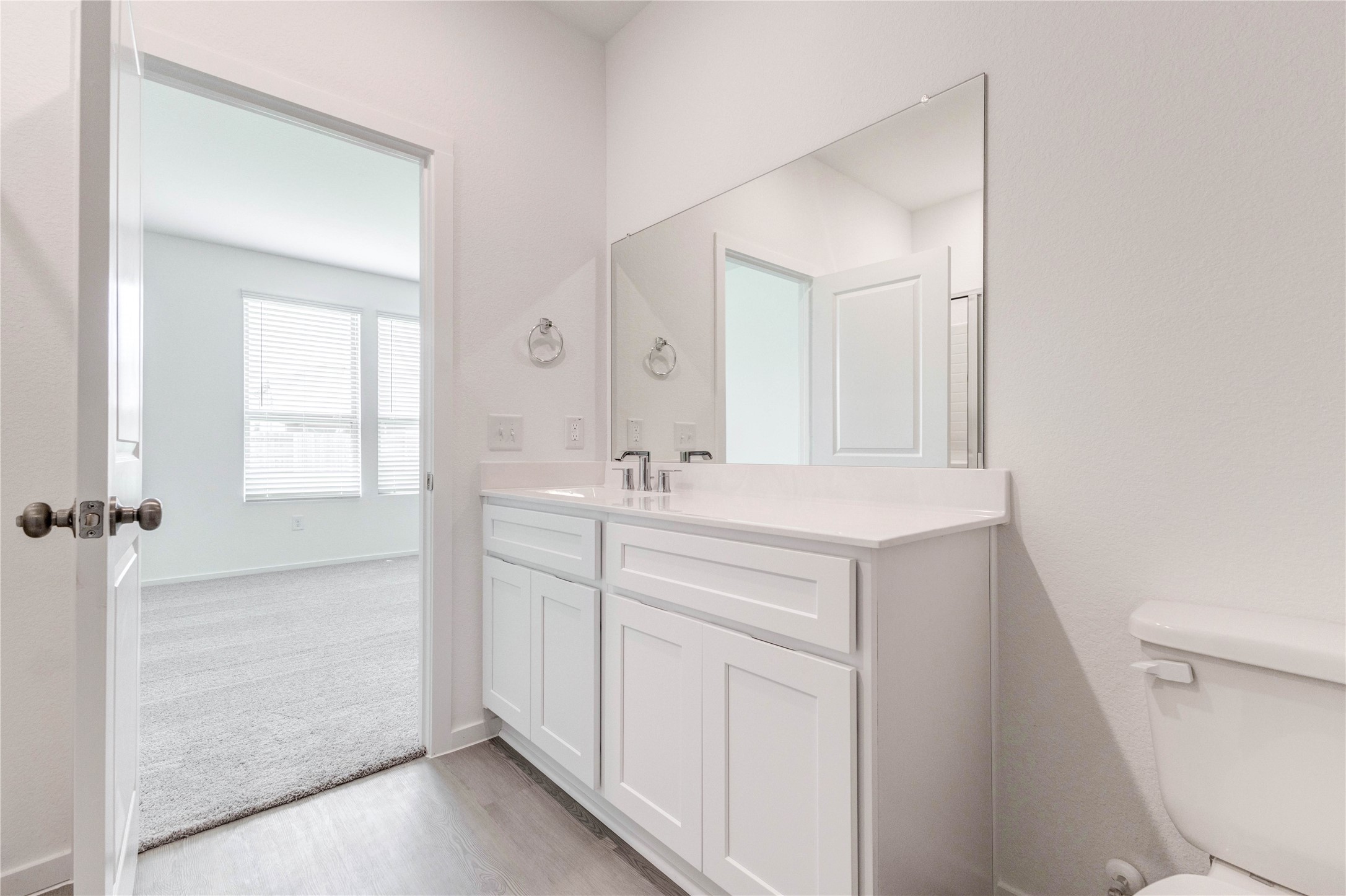 15011 Rustic Moon Road Conroe, TX 77302 - Photo 18 of 26 a bathroom with a sink a toilet a vanity and mirror