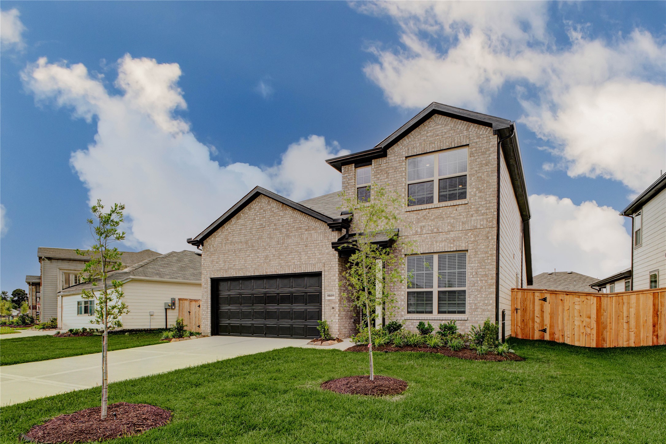 15011 Rustic Moon Road Conroe, TX 77302 - Photo 2 of 26 a front view of a house with a yard and garage