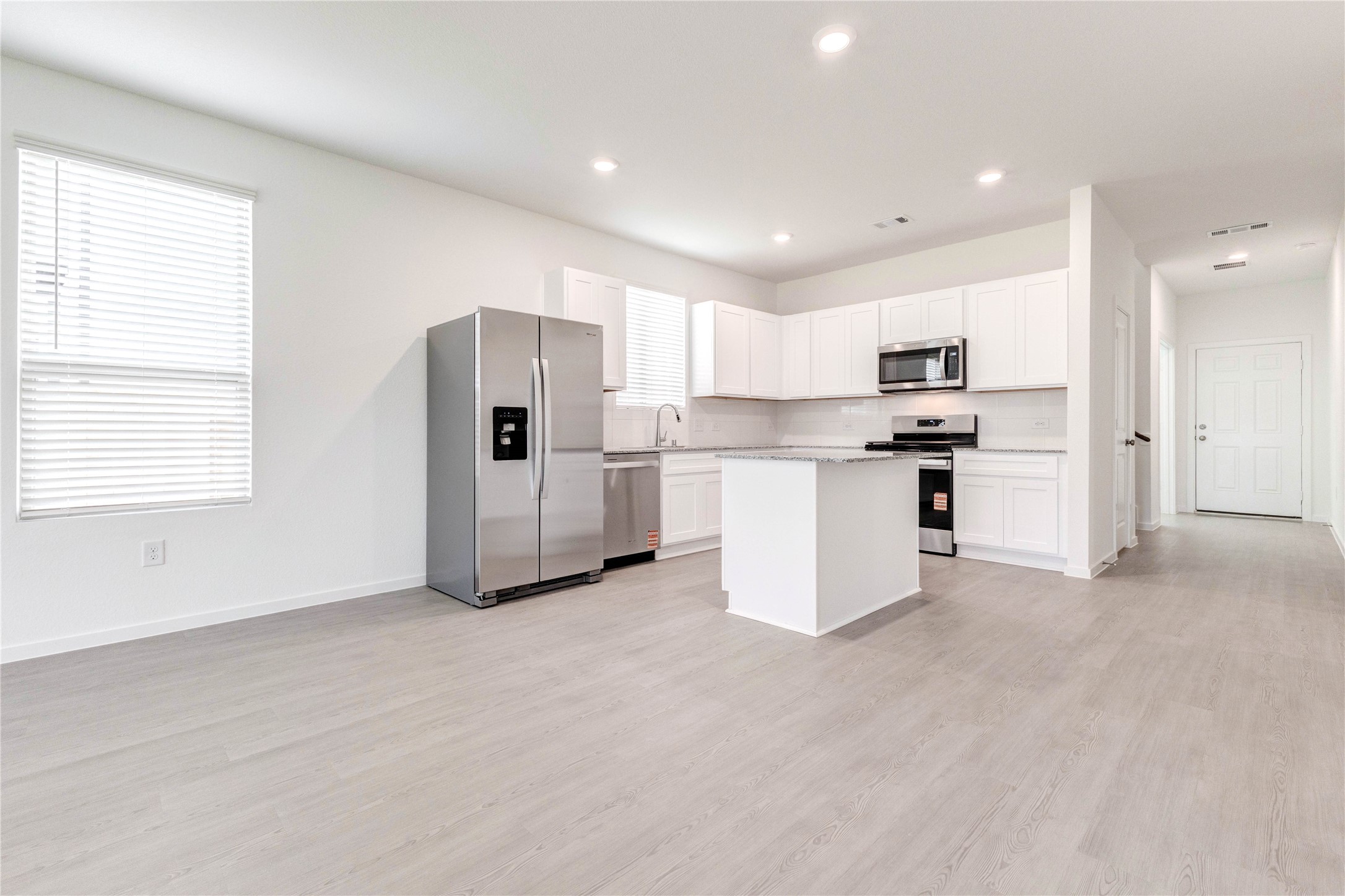15011 Rustic Moon Road Conroe, TX 77302 - Photo 9 of 26 a view of kitchen with stainless steel appliances refrigerator oven a microwave and cabinets
