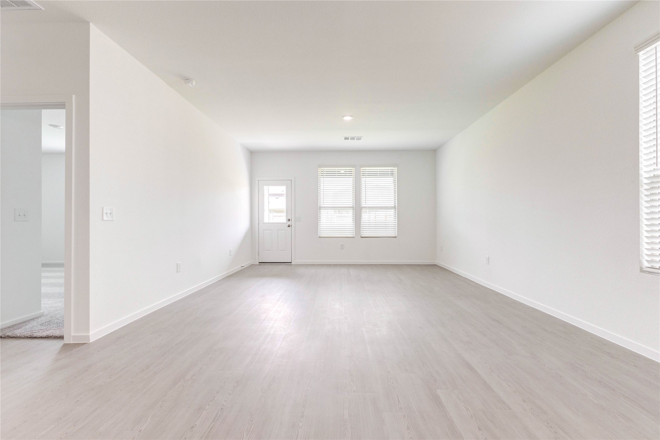 15011 Rustic Moon Road Conroe, TX 77302 - Photo 10 of 26 an empty room with wooden floor and windows