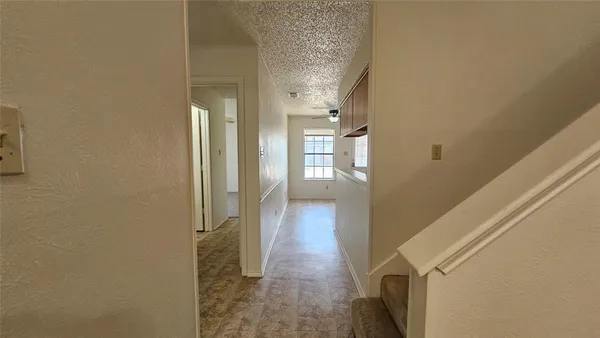 a view of a bathroom from a corridor