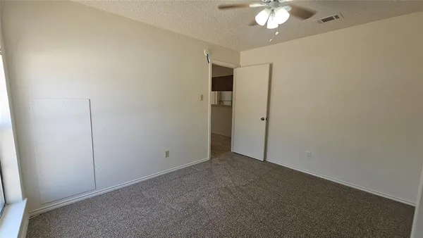 an empty room with a empty space and windows