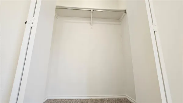 a bathroom with a granite countertop toilet and a sink