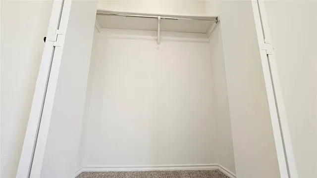 a bathroom with a granite countertop toilet and a sink