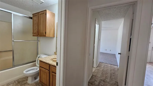 a bathroom with a toilet a sink and a mirror