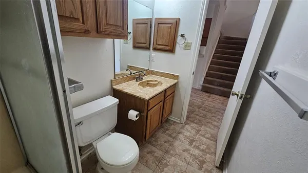 an empty room with a window and a ceiling fan