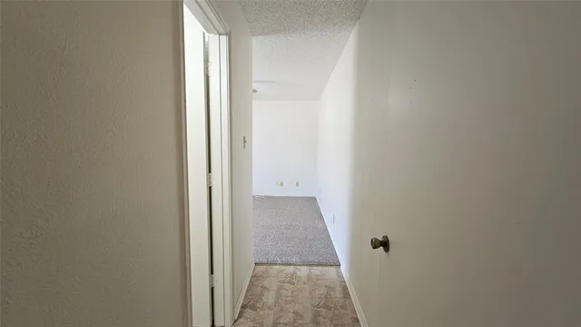 an empty room with closet and a ceiling fan