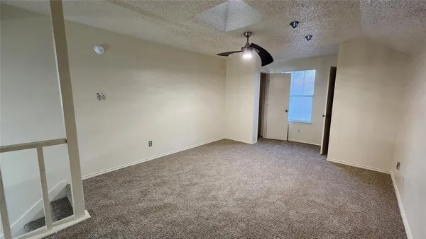 a view of an empty room with a fireplace