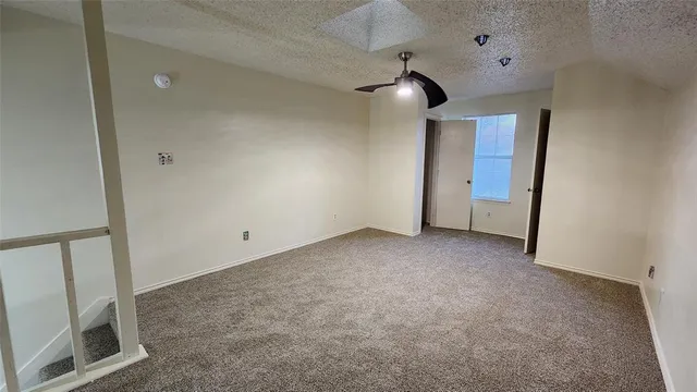 a view of an empty room with a fireplace