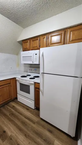 a kitchen with a refrigerator and a stove