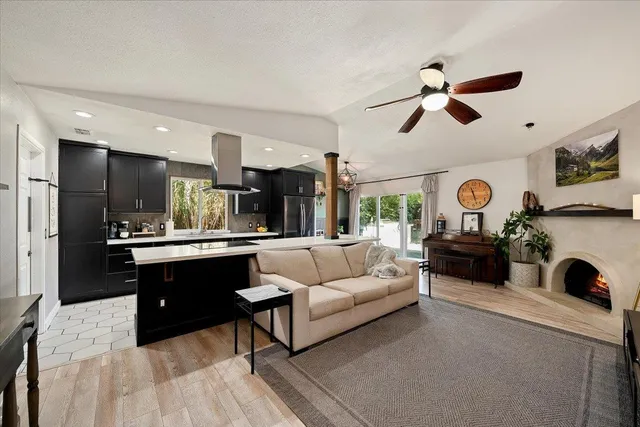 a living room with furniture and a chandelier