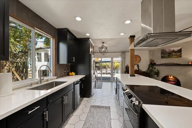 a kitchen with a stove a sink a refrigerator and wooden cabinets