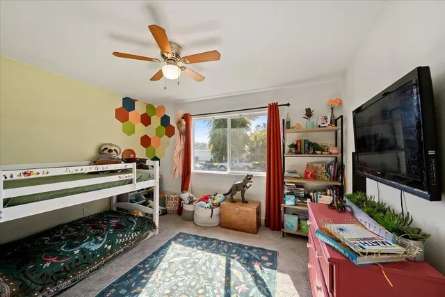 a view of a hallway with wooden floor and a living room