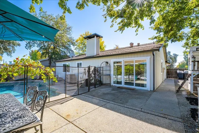 a view of a house with backyard tub and sitting area