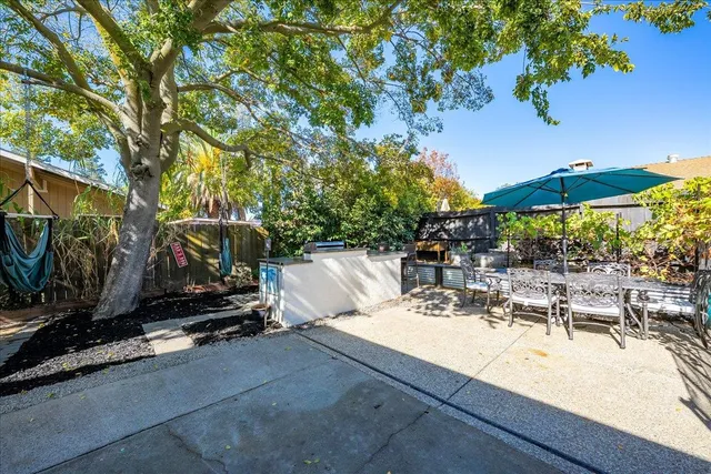 an outdoor space with seating area and trees