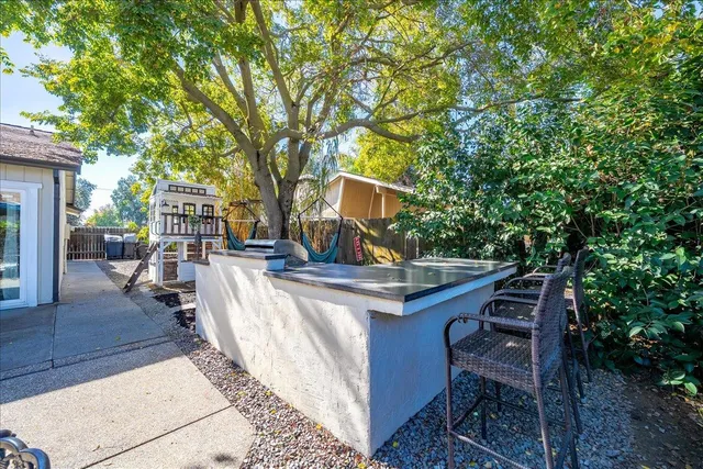 a view of a patio with table and chairs and potted plants