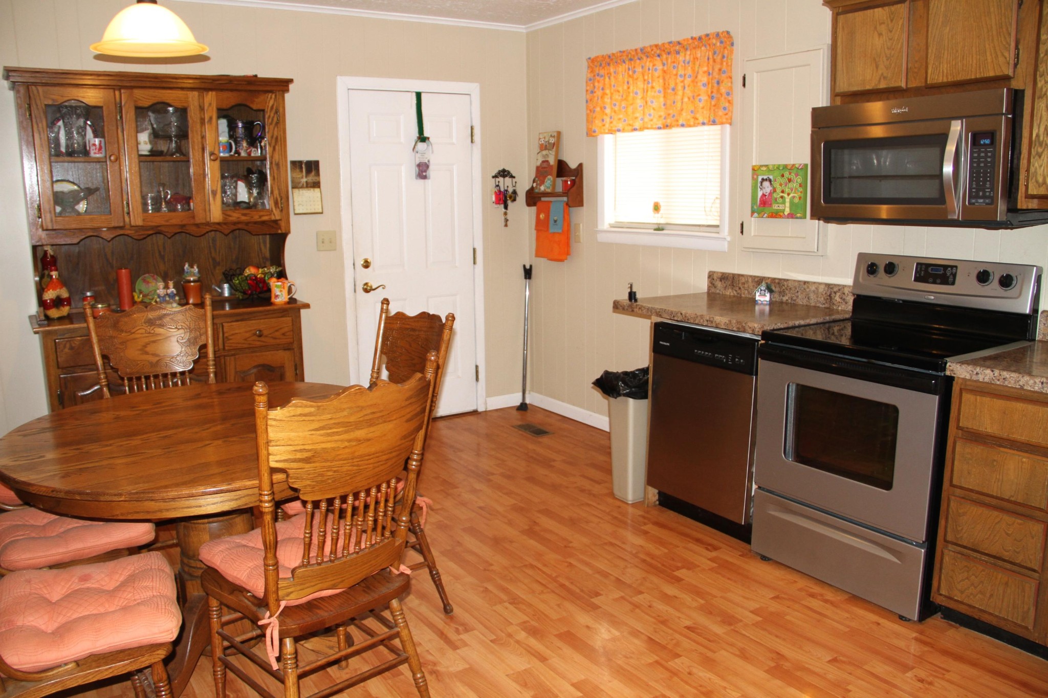 1111 Carding Machine Road Loudon, TN 37774 - Photo 6 of 21 a kitchen with stainless steel appliances kitchen island granite countertop a stove top oven a sink a dining table and chairs with wooden floor
